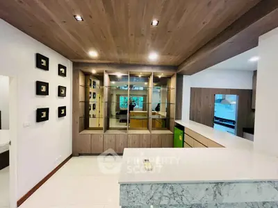 Modern kitchen with marble countertops and wooden cabinetry in a stylish home interior.