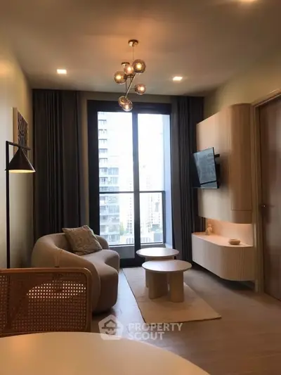 Modern living room with stylish furniture and large window offering city view