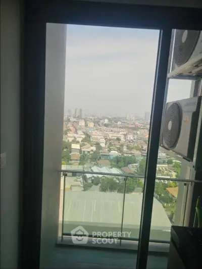 Stunning city view from a high-rise balcony with modern air conditioning units.