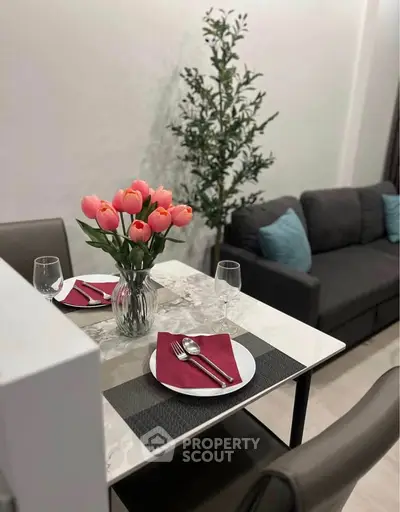 Chic dining area with elegant table setting and cozy sofa, perfect for modern living.