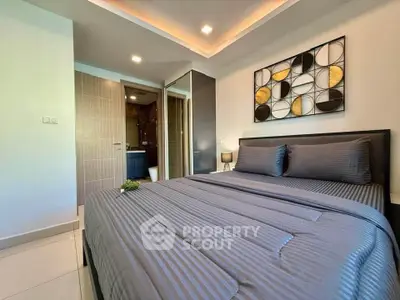 Modern bedroom with stylish decor and ensuite bathroom in luxury apartment