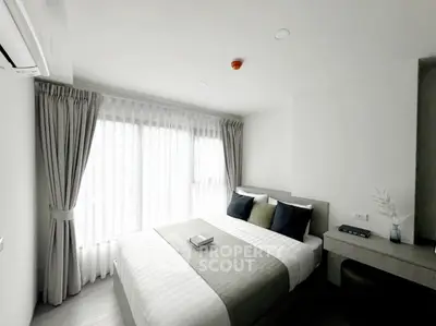 Modern bedroom with large window and stylish decor in a contemporary apartment