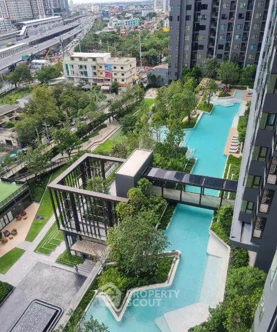 Luxurious urban apartment complex with stunning pool and lush gardens, offering a serene oasis in the city.