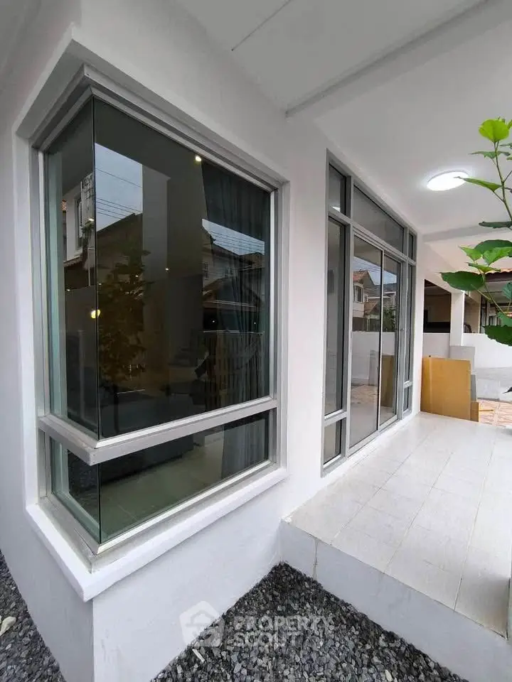 Modern exterior view of a stylish home with large windows and sleek design.