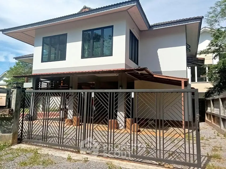 Modern two-story house with stylish metal gate and spacious driveway
