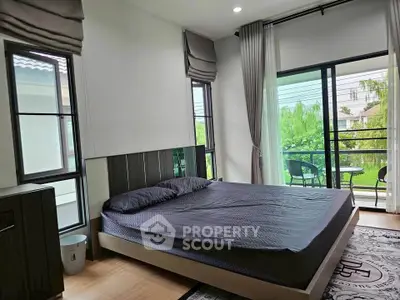 Spacious bedroom with large windows and balcony access, offering serene views and abundant natural light.