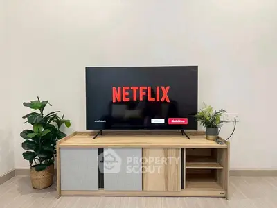 Modern living room with sleek TV stand and Netflix on screen, perfect for entertainment enthusiasts.