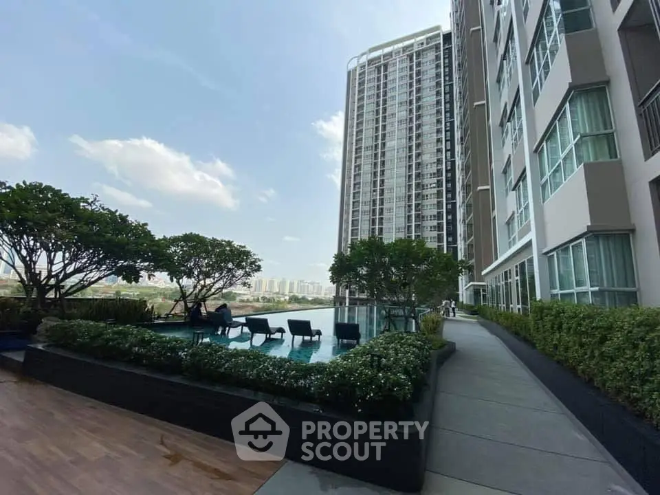 Luxurious high-rise building with rooftop pool and stunning city views.