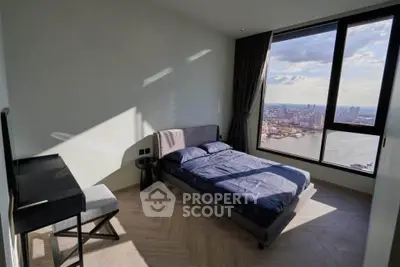 Modern bedroom with stunning city and river view from large window