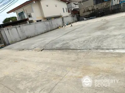 Spacious concrete parking area in residential neighborhood