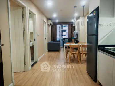 Modern apartment interior with open layout, featuring a sleek kitchen and cozy dining area.