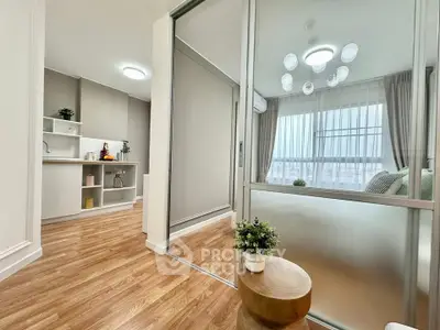 Modern living room with glass partition and stylish decor in a contemporary apartment.