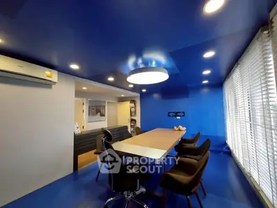 Modern study room with vibrant blue decor and sleek furniture
