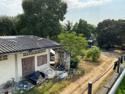 Charming rural property with rustic building and lush greenery, ideal for countryside living.