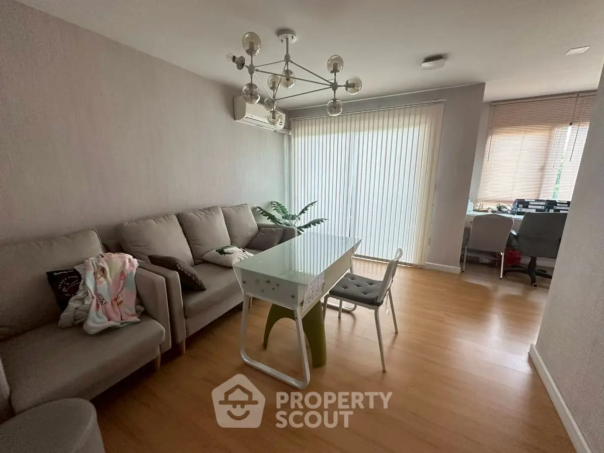 Modern living room with stylish chandelier and cozy seating area