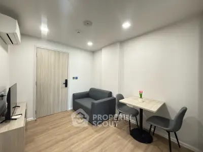 Modern living room with sleek furniture and minimalist design, featuring a cozy sofa and dining area.