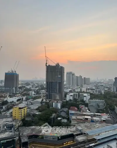 Stunning cityscape view with high-rise buildings and sunset sky, perfect for urban living enthusiasts.