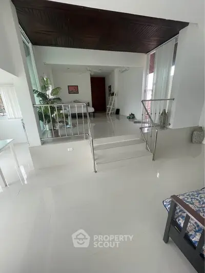Spacious modern living room with sleek design and elevated seating area, perfect for stylish urban living.