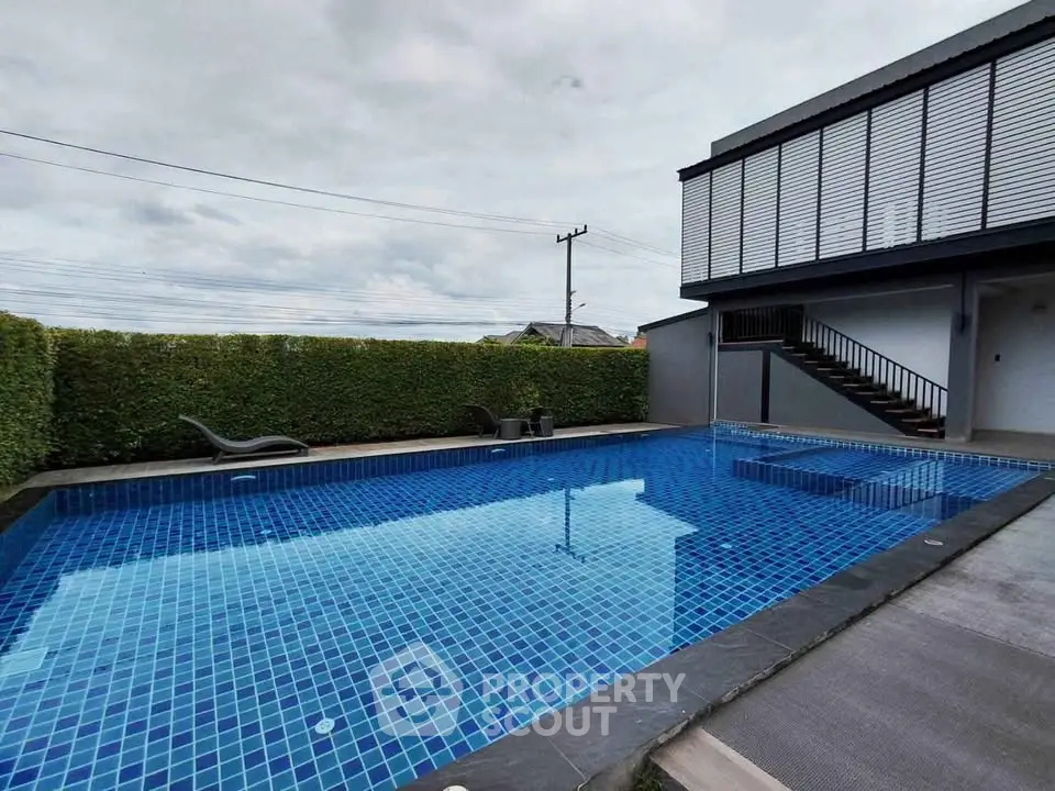 Luxurious private pool with modern design and lush greenery, perfect for relaxation and entertainment.
