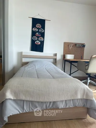 Cozy bedroom with modern decor and workspace, perfect for relaxation and productivity.