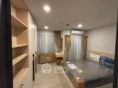 Modern bedroom with sleek design, featuring built-in shelves and cozy lighting.