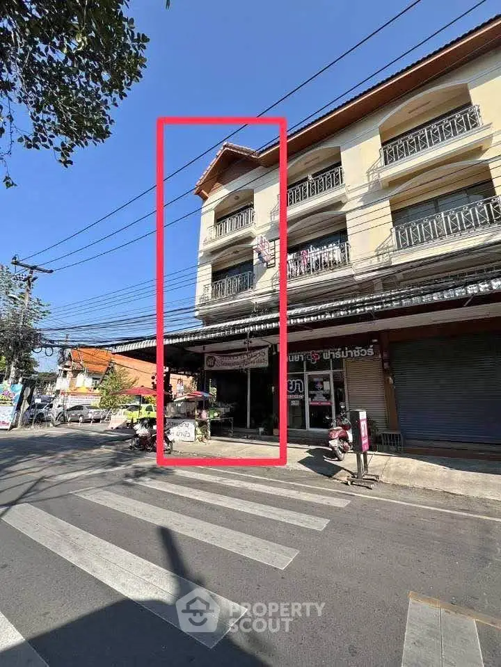 Charming three-story building with retail space on a bustling street corner, ideal for business opportunities.