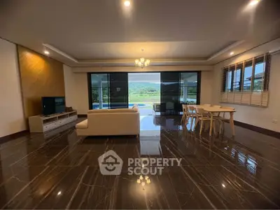 Spacious living room with elegant marble flooring and scenic view