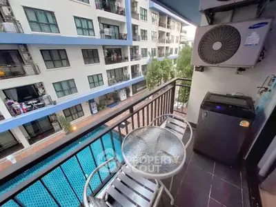 Charming balcony with pool view in modern apartment complex