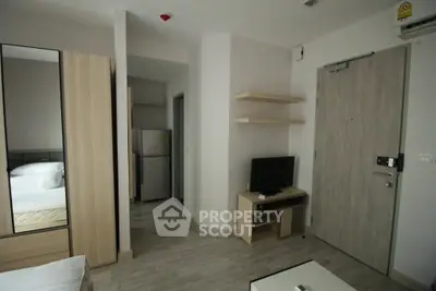 Modern apartment interior with minimalist design, featuring a cozy bedroom and compact living area.