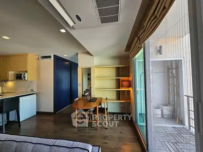 Modern living room with open kitchen and large window view