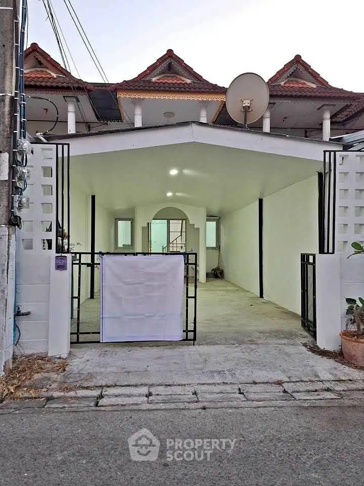 Charming townhouse with gated entrance and spacious driveway in a serene neighborhood.