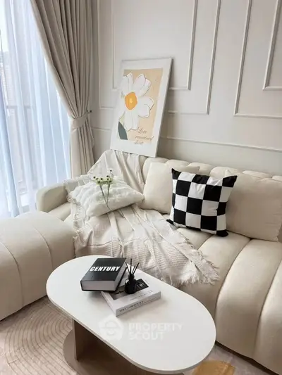 Elegant living room with plush sofa, chic decor, and natural light creating a cozy ambiance.