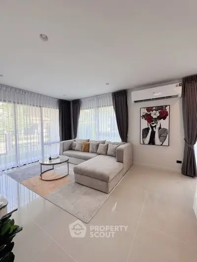 Spacious modern living room with large windows and elegant decor