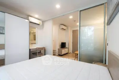 Modern bedroom with sliding glass doors and air conditioning in a stylish apartment.