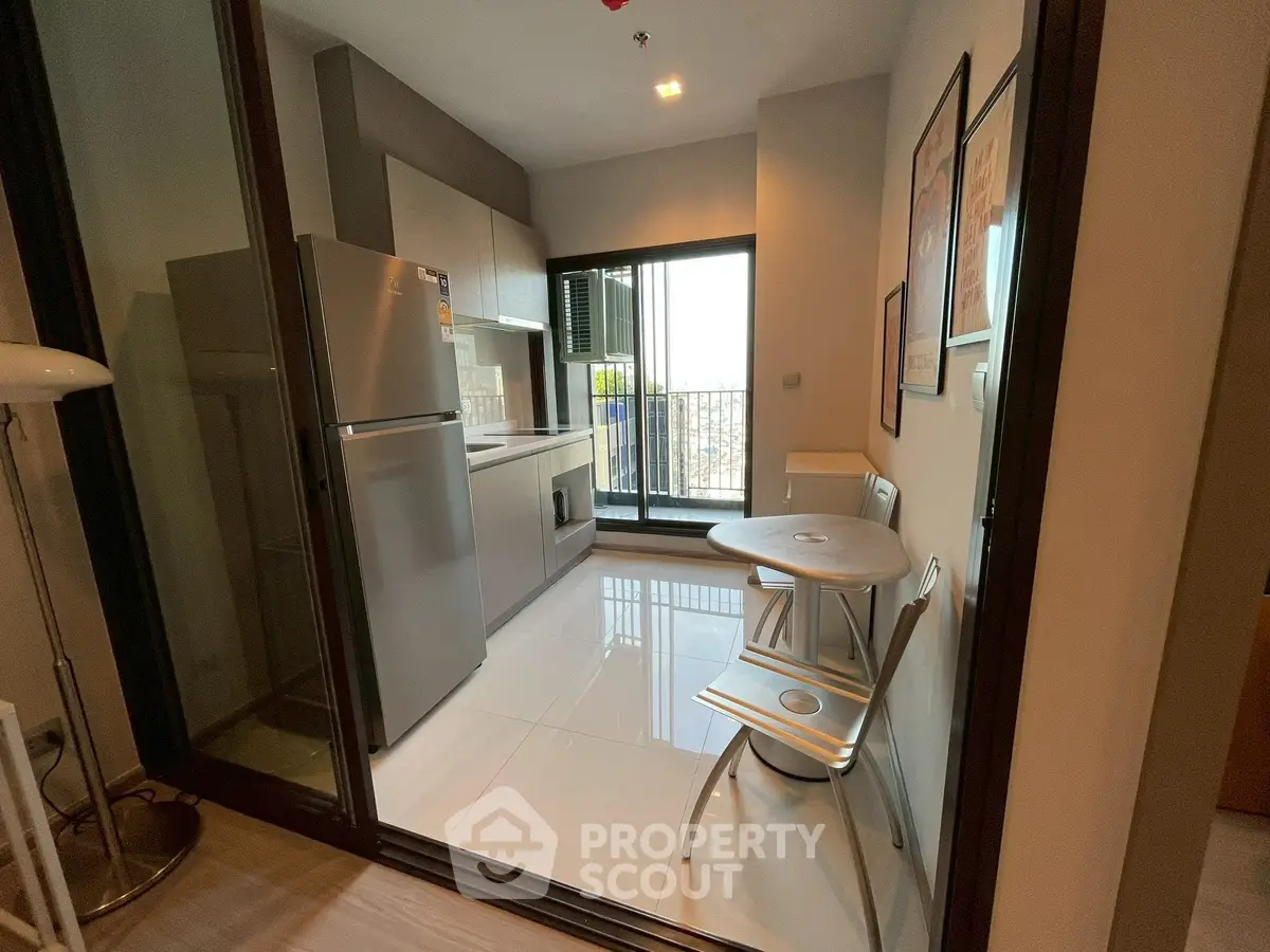 Modern kitchen with sleek appliances and balcony view
