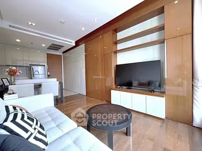 Modern living room with sleek design, open kitchen, and stylish furnishings in a contemporary apartment.