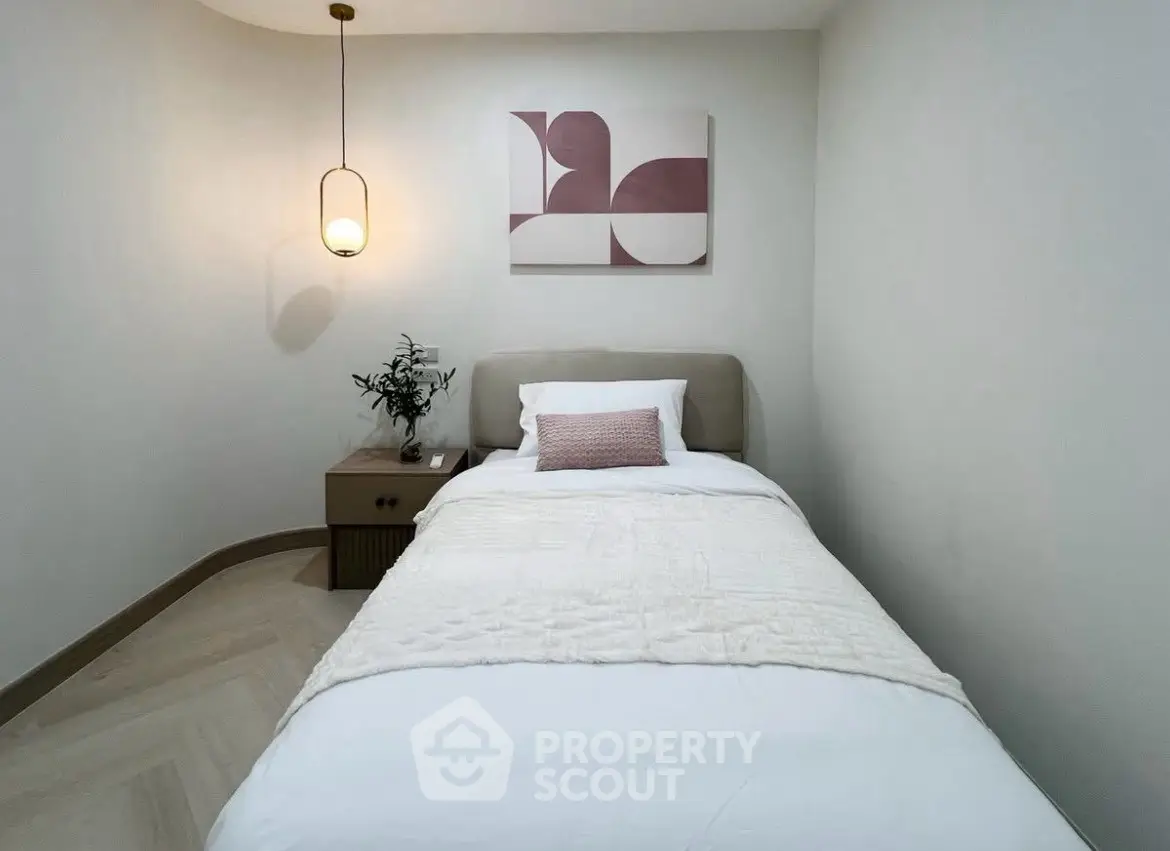 Cozy minimalist bedroom with modern decor and soft lighting, perfect for relaxation.