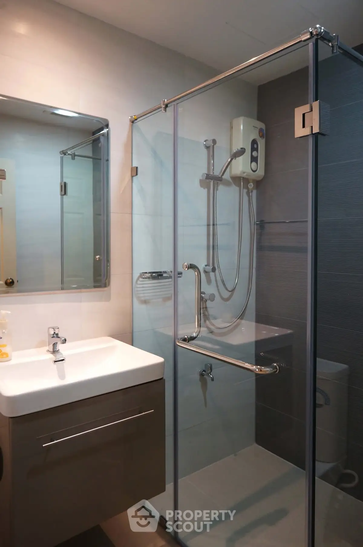 Modern bathroom with glass shower enclosure and sleek vanity