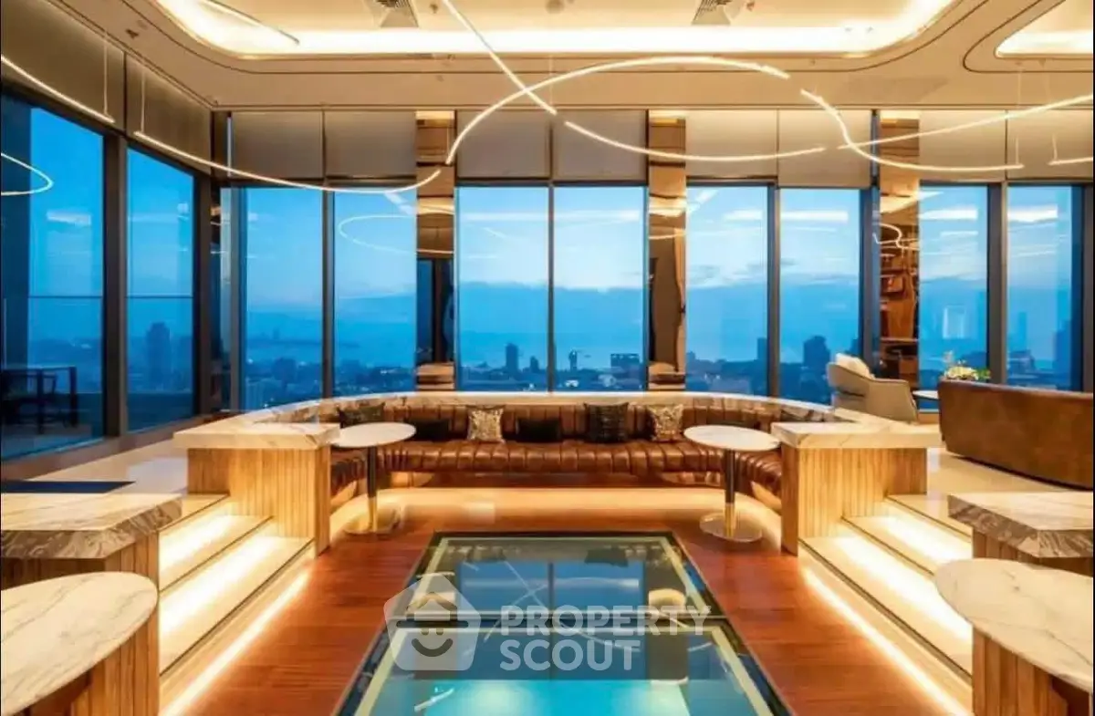 Luxurious penthouse living room with panoramic city views and modern lighting.