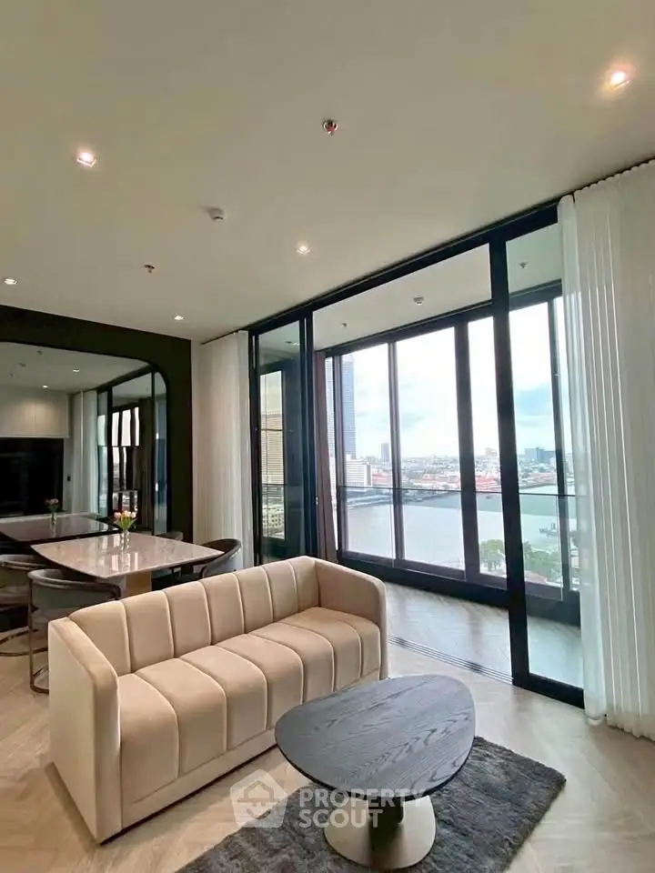 Luxurious living room with stunning river view and elegant modern furniture.