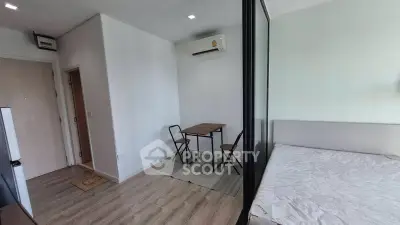 Modern studio apartment with minimalist furniture and air conditioning