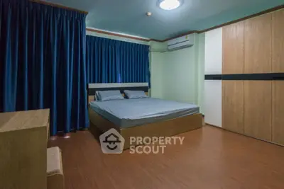 Spacious bedroom with modern furnishings and ample natural light.