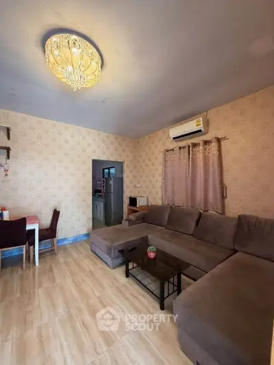 Spacious living room with elegant chandelier and cozy sectional sofa