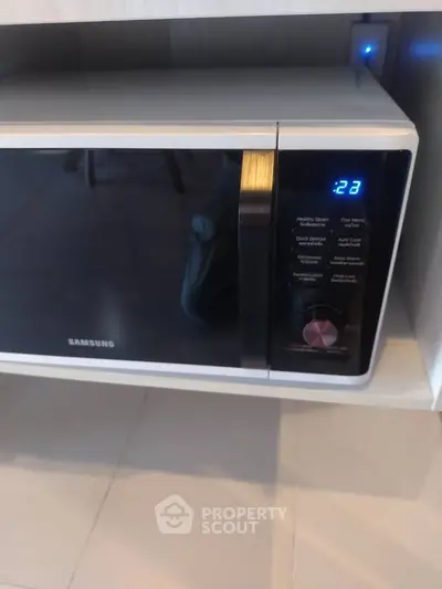 Modern kitchen microwave oven with digital display in sleek design.