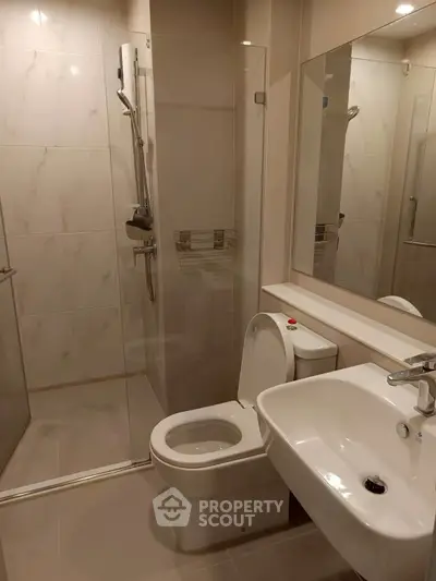 Modern bathroom with glass shower and sleek fixtures