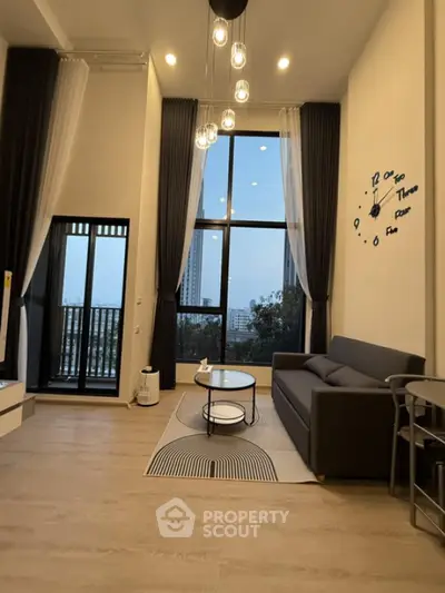 Modern living room with high ceilings and large windows offering city views