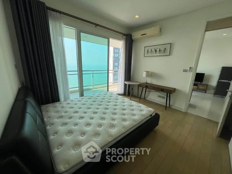 Spacious bedroom with balcony and sea view in modern apartment