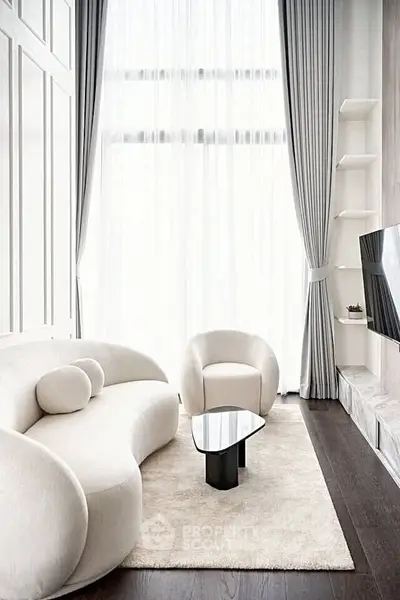 Elegant modern living room with high ceilings, stylish furniture, and floor-to-ceiling windows.