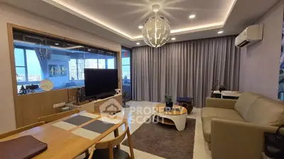 Modern living room with stylish decor and city view, featuring a cozy seating area and elegant lighting.