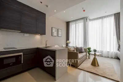 Modern open-layout kitchen and living room with sleek design and natural light